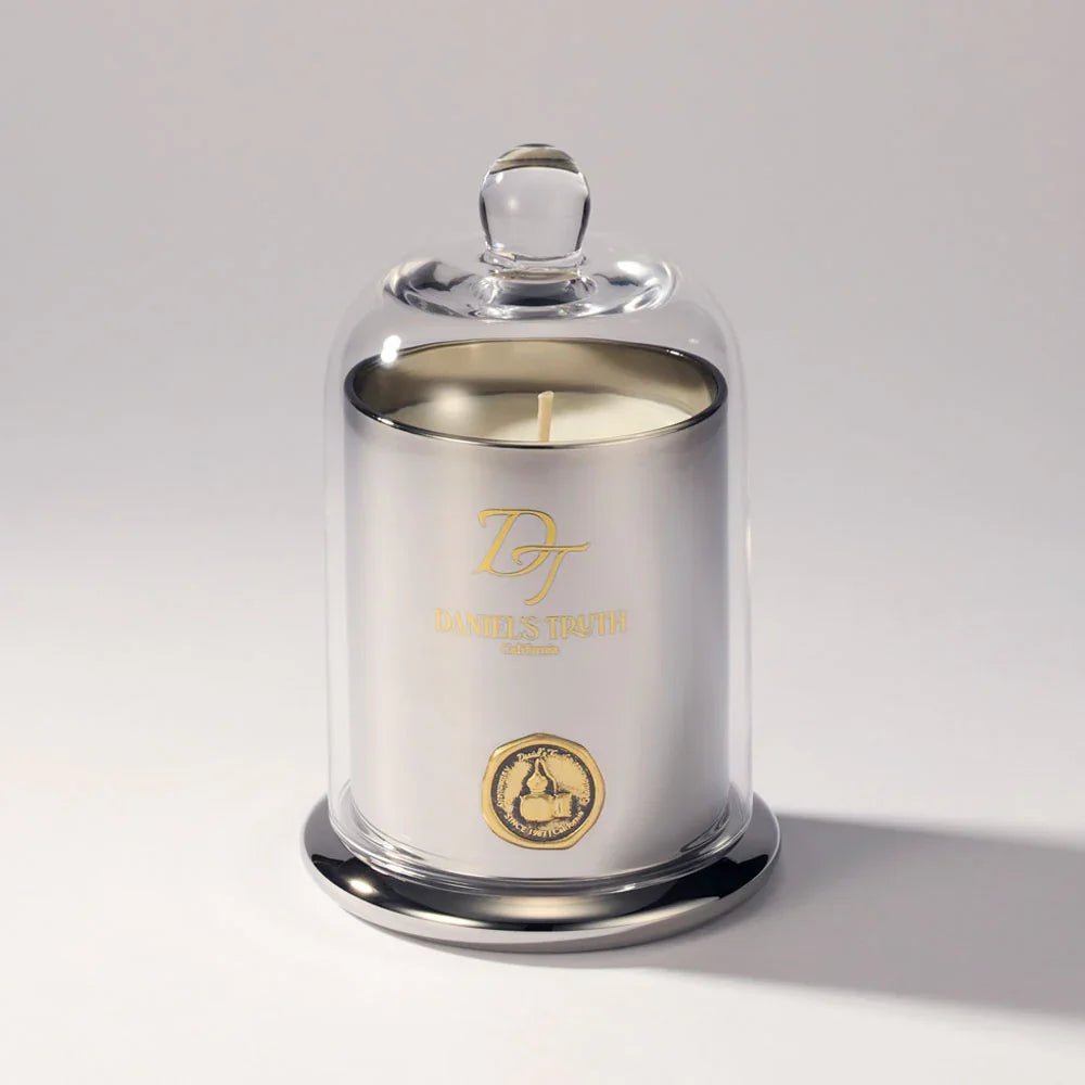 Luxury silver candle in glass cloche with gold logo and emblem on white background
