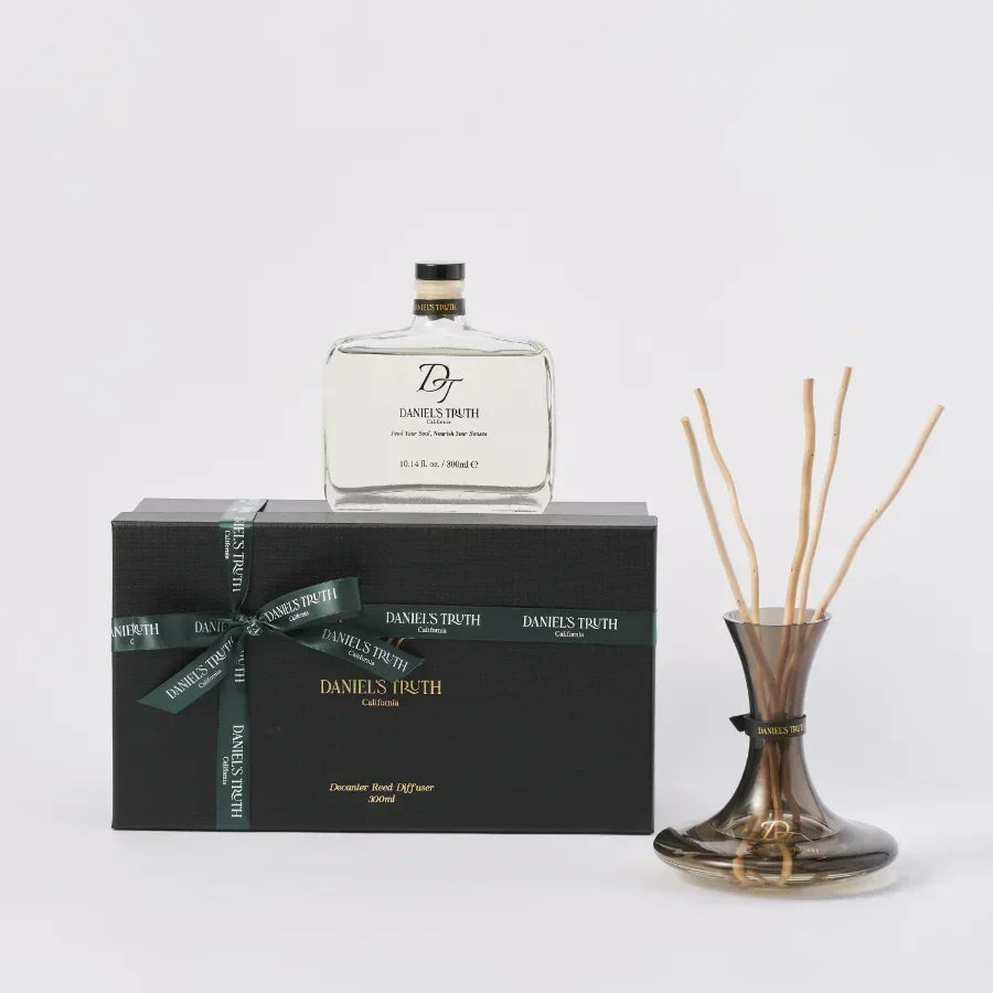 Luxury reed diffuser set with glass bottle, fragrance oil, and gift box on white background