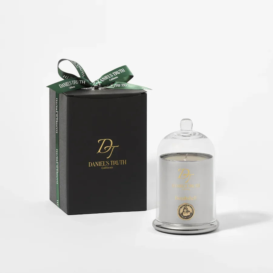 Luxury scented candle in glass dome with elegant black gift box and green ribbon