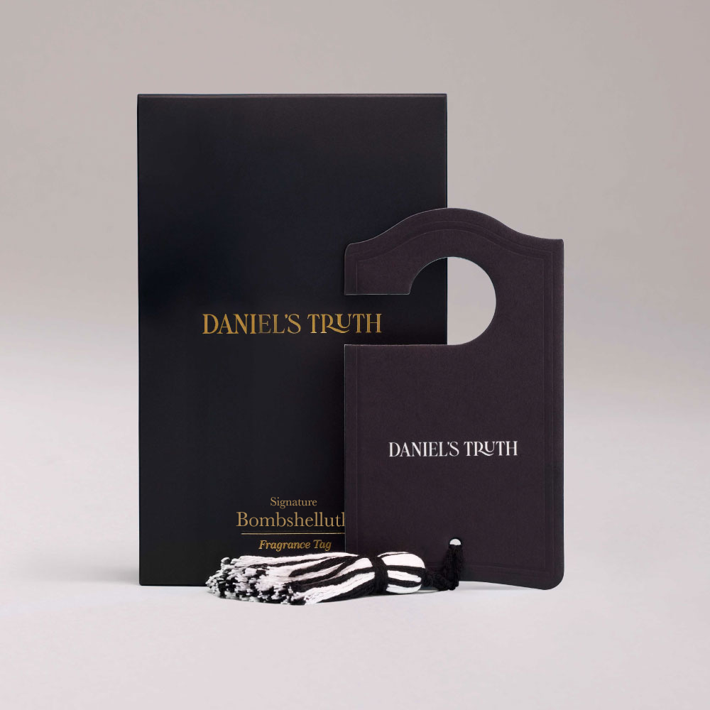 Daniel's Truth Signature Bombshelluth diffuser with a decorative fragrance tag featuring floral and elegant design elements.