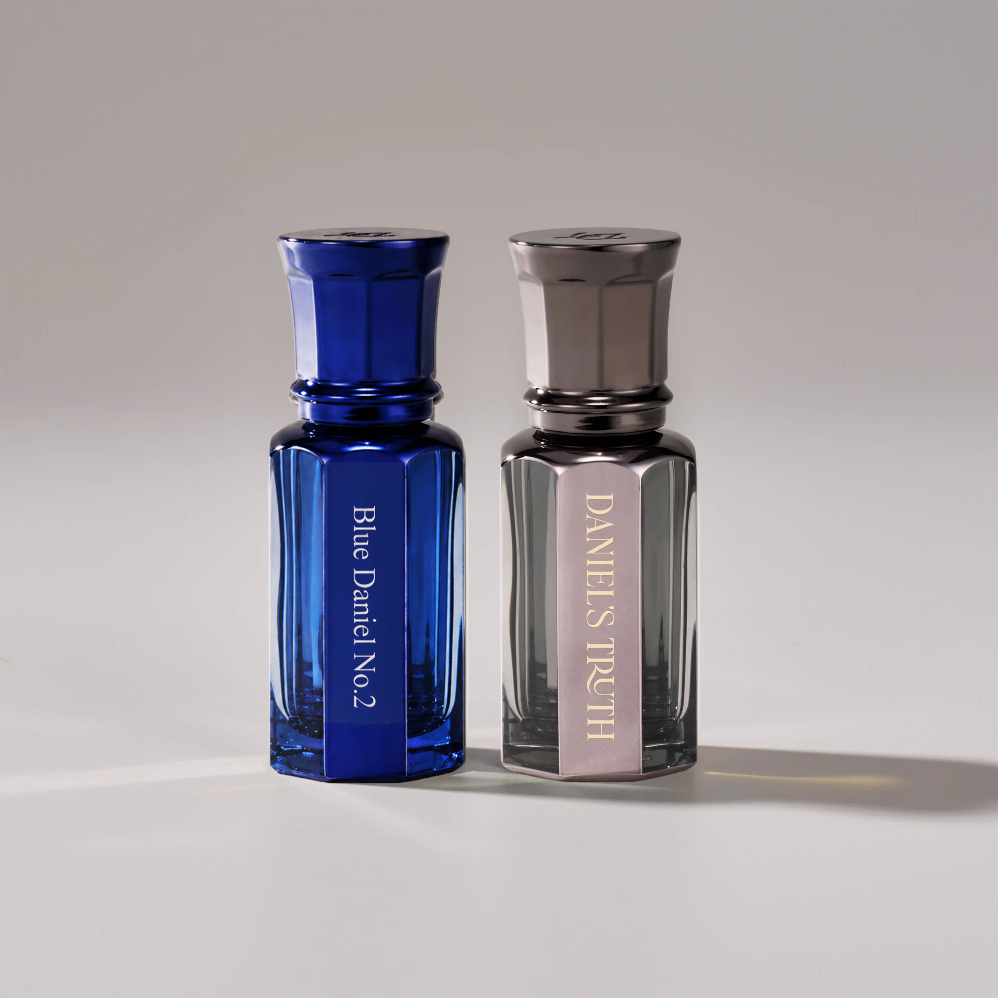 Blue Daniel 2 oil perfume set by Daniel's Truth, featuring two elegant perfume bottles with a sleek blue design.
